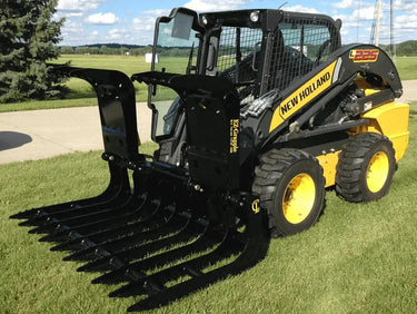 The EZ Grapple attachment is attached to the front of the skid steer loader and it has several tines or teeth.